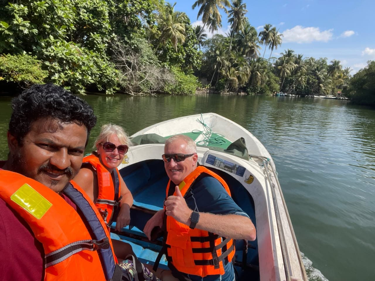 DAT Comfort host and two guests wearing life jackets during a Sri Lankan river trip