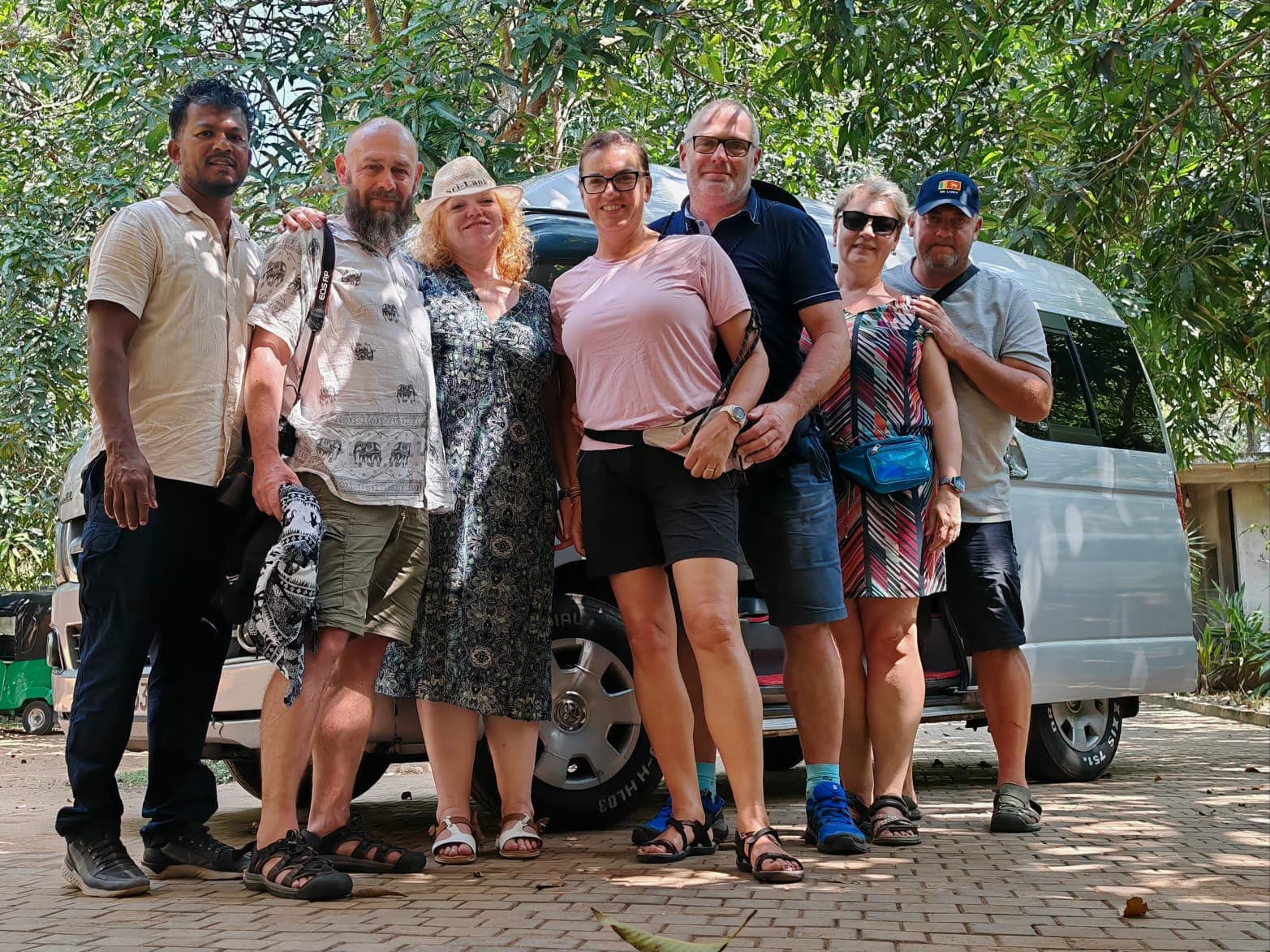 DAT Comfort host with guests beside their private vehicle